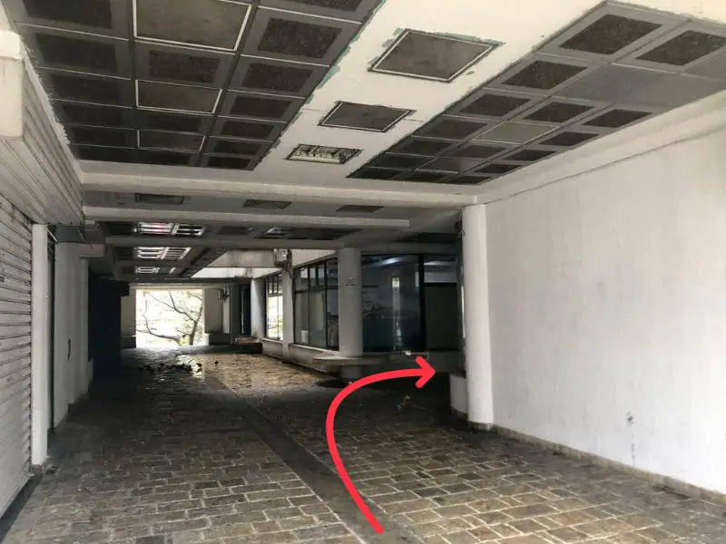 Covered gallery — walk right towards the entrance